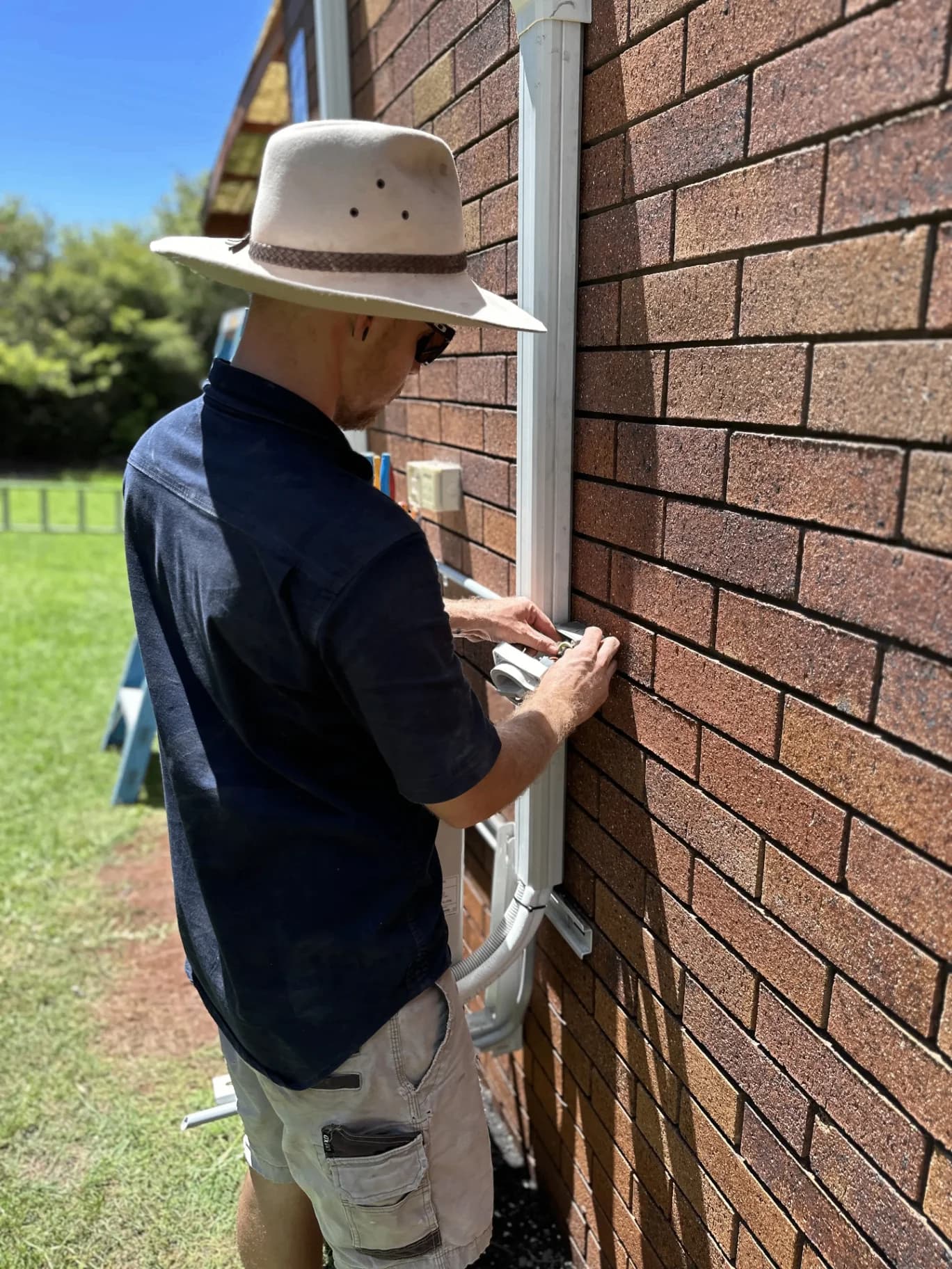 Glenn from G-TEC Electrical wiring an external conduit on a brick Toowoomba home