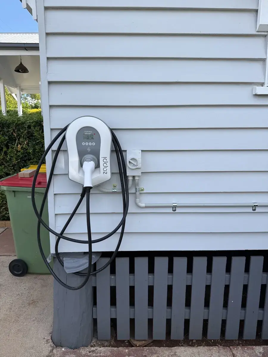 Zappi EV charger wall-mounted on weatherboard home exterior