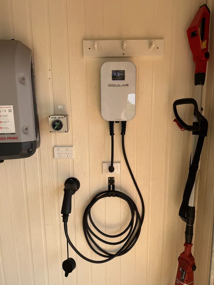 Ocular EV charger installed on garage wall with isolator switch and cable management